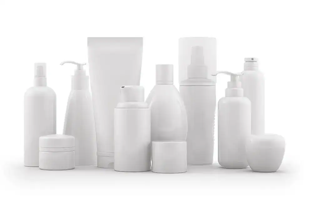 Plain white cosmetic and skincare bottles with pump and spray dispensers on white background, minimalistic beauty product display, suitable for skincare or beauty brand marketing.